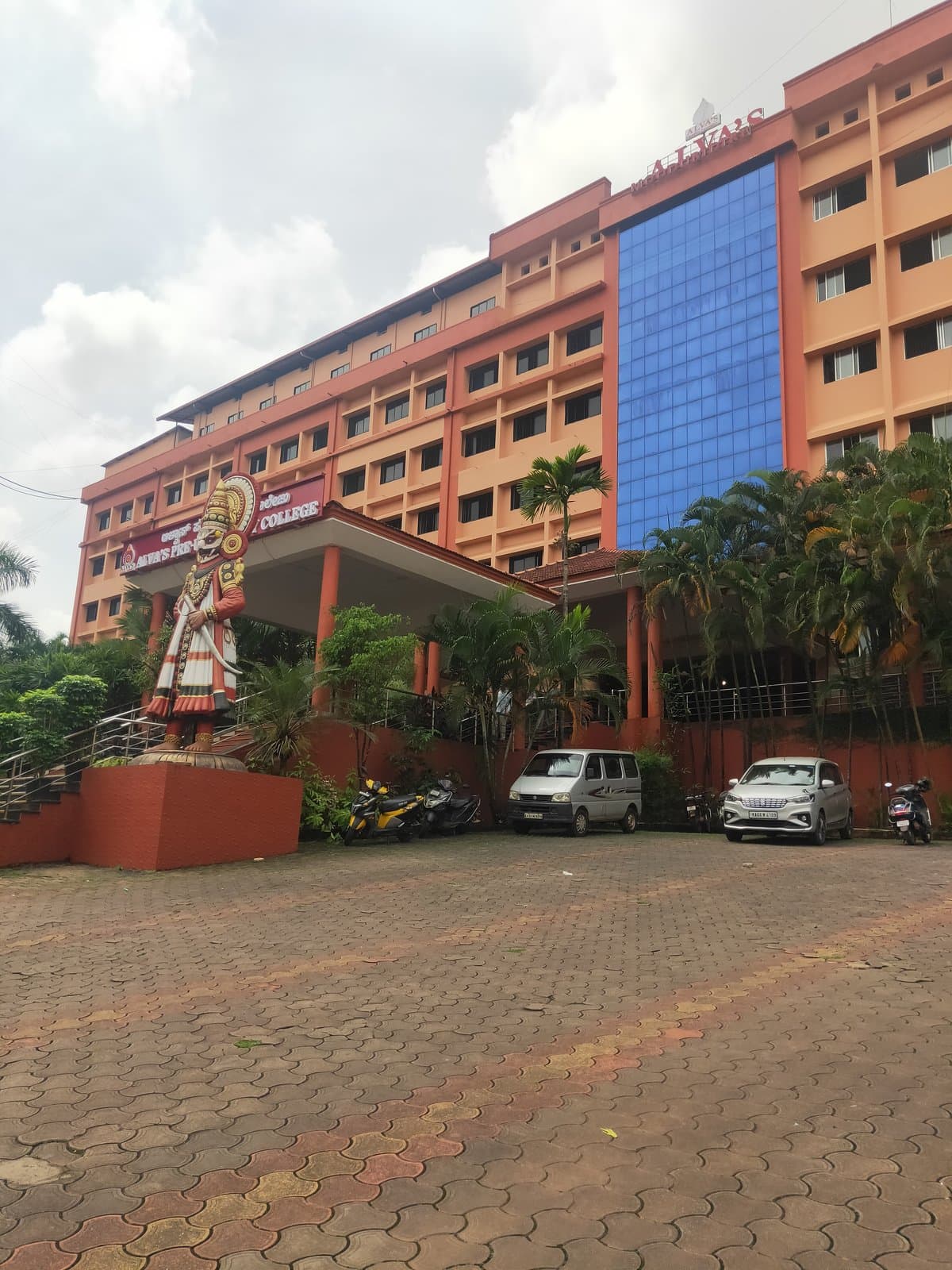 Alva's Pre-University College building with a Yakshagana figure statue at the entrance